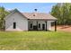 Back exterior view of a home featuring a covered patio with a stone fireplace at 48 Paschal St, Temple, GA 30179