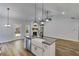 Bright kitchen features a granite island, farmhouse sink, and stainless steel appliances at 48 Paschal St, Temple, GA 30179