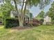 A well-kept backyard featuring a wooden deck, mature trees, and verdant lawn at 4812 Shallow Creek Nw Dr, Kennesaw, GA 30144