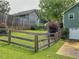 Fenced backyard featuring green lawn, lush plantings, and view of the home's exterior at 4812 Shallow Creek Nw Dr, Kennesaw, GA 30144