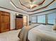 Bright bedroom with neutral carpet, bay window, and tray ceiling at 4812 Shallow Creek Nw Dr, Kennesaw, GA 30144
