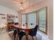 Bright dining room with elegant lighting, large windows, and a classic dining table at 4812 Shallow Creek Nw Dr, Kennesaw, GA 30144