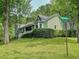 Beautiful home with lush green lawn and mature trees on a corner lot at 4812 Shallow Creek Nw Dr, Kennesaw, GA 30144
