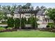 An inviting backyard swing is surrounded by perfectly manicured green shrubs and trees at 6445 Lucent Ln, Atlanta, GA 30328