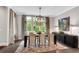 Elegant dining room with a large window, contemporary chandelier, and chic decor at 6445 Lucent Ln, Atlanta, GA 30328