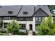 Charming townhome showcasing a stylish front elevation, beautiful landscaping, and inviting curb appeal at 6445 Lucent Ln, Atlanta, GA 30328