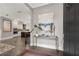 Inviting foyer with hardwood floors, console table, and view of a modern kitchen with stainless steel appliances at 6445 Lucent Ln, Atlanta, GA 30328