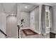 Hallway with hardwood floors, a stylish rug, and a door with sidelight window and neutral gray walls at 6445 Lucent Ln, Atlanta, GA 30328