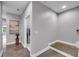 Bright hallway with wood floors and access to the laundry room at 6445 Lucent Ln, Atlanta, GA 30328