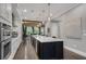 Modern kitchen with an island, stainless steel appliances, pendant lights, and hardwood floors at 6445 Lucent Ln, Atlanta, GA 30328