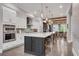 Spacious kitchen featuring a large island, stainless steel appliances, and white cabinets at 6445 Lucent Ln, Atlanta, GA 30328