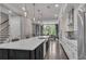 Kitchen featuring an island with bar stool seating, stainless steel appliances, and view of the dining room at 6445 Lucent Ln, Atlanta, GA 30328