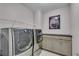 Well-equipped laundry room with modern washer and dryer and granite countertops at 6445 Lucent Ln, Atlanta, GA 30328