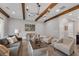 Comfortable living room with neutral tones, wood beam ceiling, and stylish furnishings at 6445 Lucent Ln, Atlanta, GA 30328