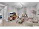 Living room with modern décor, wood floors, stylish light fixture, and comfortable seating at 6445 Lucent Ln, Atlanta, GA 30328