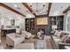 Open-concept living area with fireplace, built-in shelving, wood beams, and adjacent modern kitchen at 6445 Lucent Ln, Atlanta, GA 30328