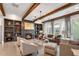 Inviting living room with a cozy fireplace, custom built-ins, wood beams, and stylish chandelier at 6445 Lucent Ln, Atlanta, GA 30328