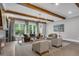 Stylish living room with wooden beams, comfortable seating, large windows, and hardwood floors at 6445 Lucent Ln, Atlanta, GA 30328