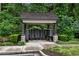 A community mailbox pavilion surrounded by lush green foliage for residents to gather their mail at 6445 Lucent Ln, Atlanta, GA 30328