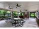 An outdoor lounge and dining area with a fireplace and ceiling fans for community residents to enjoy at 6445 Lucent Ln, Atlanta, GA 30328