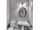 Stylish powder room featuring a pedestal sink and decorative mirror at 6445 Lucent Ln, Atlanta, GA 30328