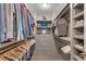 Organized walk-in closet with ample hanging space, shelving, and drawers at 6445 Lucent Ln, Atlanta, GA 30328