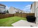 View of backyard featuring lawn, patio, and wooden privacy fence at 1295 Aster Ives Dr, Lawrenceville, GA 30045