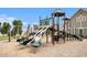 A green and tan playground features multiple slides, climbing structures, and a shaded area at 1295 Aster Ives Dr, Lawrenceville, GA 30045