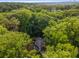 An aerial view of a home nestled in a canopy of lush green trees and landscaping at 1461 Bubbling Creek Ne Rd, Brookhaven, GA 30319