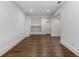 Clean, well-lit basement featuring hardwood floors, white walls and trim, recessed lighting, and a built-in shelving unit at 1461 Bubbling Creek Ne Rd, Brookhaven, GA 30319