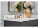Bathroom vanity featuring gray cabinets, a white countertop, gold fixtures, and decorative vase at 1461 Bubbling Creek Ne Rd, Brookhaven, GA 30319