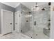 Elegant bathroom featuring a glass enclosed shower with marble surround and decorative chandelier at 1461 Bubbling Creek Ne Rd, Brookhaven, GA 30319