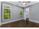 Bright bedroom with wood floors, two windows that offer lush green views and a doorway leading to a spacious walk-in closet at 1461 Bubbling Creek Ne Rd, Brookhaven, GA 30319