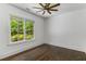 Bright bedroom featuring hardwood floors, white trim, and a large window providing a wooded view at 1461 Bubbling Creek Ne Rd, Brookhaven, GA 30319