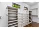 Custom walk-in closet featuring built-in shelves, drawers, and ample storage space, with hardwood floor at 1461 Bubbling Creek Ne Rd, Brookhaven, GA 30319