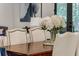 Dining room with a wood table, upholstered chairs, and decorative floral arrangement at 1461 Bubbling Creek Ne Rd, Brookhaven, GA 30319