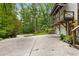 Long driveway leads to a three-car garage with a second-story porch overlooking the landscaped backyard at 1461 Bubbling Creek Ne Rd, Brookhaven, GA 30319
