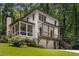Two-story home with white siding, a screened-in porch, a walk-out basement, and a two-car garage at 1461 Bubbling Creek Ne Rd, Brookhaven, GA 30319