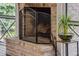 Close-up of the brick fireplace and hearth in the screened porch at 1461 Bubbling Creek Ne Rd, Brookhaven, GA 30319