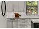 Bright kitchen featuring white cabinets, countertops, and view of a wooded backyard at 1461 Bubbling Creek Ne Rd, Brookhaven, GA 30319