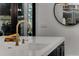 Kitchen island with white countertop, sink, and gold faucet with dark cabinets at 1461 Bubbling Creek Ne Rd, Brookhaven, GA 30319
