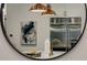 Bright kitchen reflecting in a round mirror, featuring stainless steel appliances and copper pendant lights at 1461 Bubbling Creek Ne Rd, Brookhaven, GA 30319