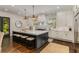 Bright kitchen with large island, seating, stainless appliances, pendant lights, and white cabinets at 1461 Bubbling Creek Ne Rd, Brookhaven, GA 30319