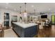 Large open-concept kitchen with island, stainless steel refrigerator, and adjacent living areas at 1461 Bubbling Creek Ne Rd, Brookhaven, GA 30319