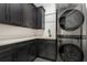 Well-organized laundry room featuring dark cabinets, quartz countertops and a new washer/dryer at 1461 Bubbling Creek Ne Rd, Brookhaven, GA 30319