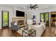 Cozy living room featuring a brick fireplace, dark trim windows, and hardwood floors at 1461 Bubbling Creek Ne Rd, Brookhaven, GA 30319