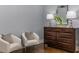 Stylish bedroom furniture with throw pillows, two side chairs, and a large dresser at 1461 Bubbling Creek Ne Rd, Brookhaven, GA 30319