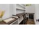 Pantry with dark wood countertops and shelving, beverage refrigerator and stylish fixtures at 1461 Bubbling Creek Ne Rd, Brookhaven, GA 30319