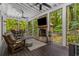 Inviting screened porch with a brick fireplace, ceiling fans, and wooded views at 1461 Bubbling Creek Ne Rd, Brookhaven, GA 30319