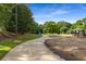 A paved walking trail winds through a park featuring lush greenery and recreational facilities at 1461 Bubbling Creek Ne Rd, Brookhaven, GA 30319